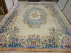 A CHINESE WASHED WOOLLEN CARPET, predominantly cream ground with multiple floral pattern, 376 x