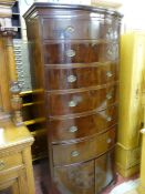 A TALL MAHOGANY BOW FRONT CHEST OF SIX DRAWERS with two door lower shoe cupboard on corner bracket