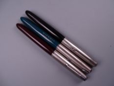 Three Vintage Parker 51 fountain pens (black, red, and green with engraved barrel)