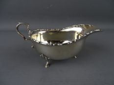 A SILVER SAUCE BOAT on three hoof feet, 16 cms long, London 1919, 3 troy ozs