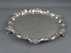 A SILVER THREE FOOTED SALVER with floral edge decoration, Sheffield 1869, 15.1 troy ozs, 26.5 cms