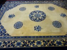 A LARGE BLUE & CREAM WASHED WOOLLEN CHINESE CARPET with tasselled ends, 375 x 276 cms
