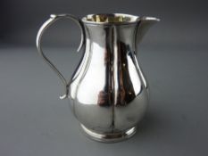 AN EARLY SILVER CREAM JUG with narrow neck to a bulbous base, 2.5 ozs, maker's mark indistinct,
