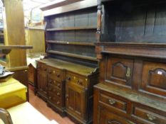 AN OAK WELSH DRESSER, mid to late 19th Century having a shaped three shelf rack over a breakfront