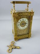 A FRENCH GILT BRASS FOUR PANE CARRIAGE CLOCK, ivorine dial in a foliate mask, the case with