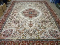 A GOOD EASTERN WOOLLEN CARPET with central medallion on a cream ground, repeating tree pattern and