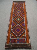 A Suzni Kilim runner colourful, multi diamond pattern with chequered border 240 x 75cms