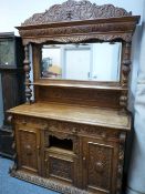 A SUBSTANTIAL CARVED OAK VICTORIAN MIRROR BACK SIDEBOARD with mask, fruit and leaf detail, 233 cms