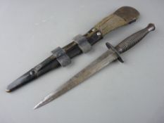 A SYKES FAIRBAIRN TYPE COMMANDO KNIFE in scabbard, the upper grip stamped 'No. 1' with top nut