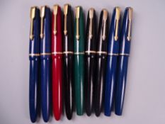 Four Vintage Parker Slimfold fountain pens (one black, two blue, one red), black cap damaged, all