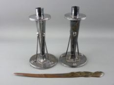 A PAIR OF ART NOUVEAU SILVER PLATED CANDLESTICKS and a Ges Gesch floral formed letter opener, 19 cms