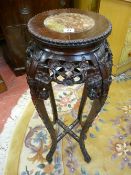 A CHINESE CARVED HARDWOOD STAND with inset marble top, 93 cms high, 28 cms diameter top