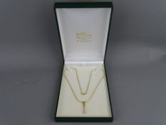 AN EIGHTEEN CARAT GOLD & QUARTER CARAT DIAMOND PENDANT DROP on chain, 'C J W' makers and London