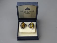 A PAIR OF 925 SILVER CLIP-ON EARRINGS with large cabochon ambers, approximately 2 x 1 cms, 8.8 grms