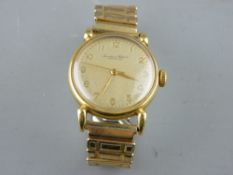 AN EIGHTEEN CARAT GOLD CASED GENT'S WRISTWATCH with plated expanding strap, the dial marked '