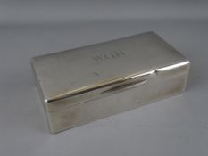A RECTANGULAR SILVER CIGARETTE BOX with cedar wood lining, London 1922, 17.5 cms long