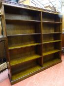 A REPRODUCTION OAK OPEN BOOKCASE with adjustable interior shelves, 152.5 cms high, 165 cms wide,