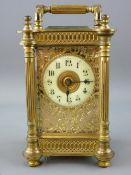 AN ORNATE FRENCH GILT BRASS CARRIAGE CLOCK with visible escapement and pierced fret front, in