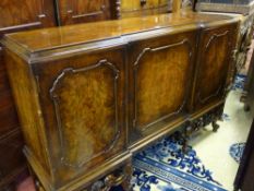 A WALNUT INVERTED BREAKFRONT SIDEBOARD having a classically styled sub-frame, 102 cms high, 152