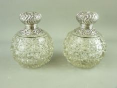 A PAIR OF GLOBULAR HOBNAIL CUT SCENT BOTTLES with embossed silver tops and collars, Birmingham 1899,
