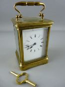A BRASS CASED CARRIAGE CLOCK with gong strike movement, 16 cms high handle up, with key