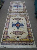 A pair of silk style rugs with aztec type design 185 x 135cms