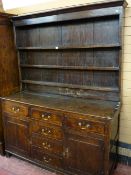 AN EARLY 19th CENTURY OAK FRONT DRESSER, the base section having fully opening pine lined drawers