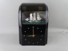 A VITASCOPE BLACK BAKELITE AUTOMATON CLOCK with threemaster ship