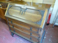 AN OAK FALL FRONT BUREAU with carved detail on barley twist supports, 104 cms high, 90.5 cms wide,