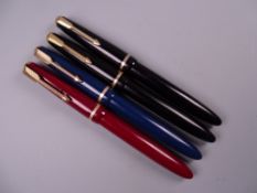 Four Vintage Parker Slimfold fountain pens (two black, one blue, one red), all with 14k nibs