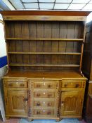 AN ANGLESEY OAK & MAHOGANY BREAKFRONT DRESSER, fully opening drawers with diamond escutcheons and