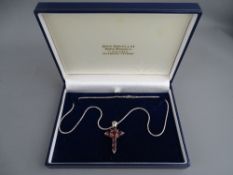 A SILVER 'STG 925' MARKED SNAKE CHAIN and large pendant cross set with facet cut purple stones