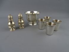 A STERLING SILVER BOWL, four small beakers and a pair of Chester 1906 pepper pots, 5.3 troy ozs