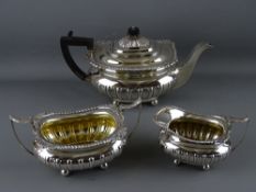 AN EXCELLENT THREE PIECE SILVER TEA SERVICE on ball feet, Sheffield 1911, 45 troy ozs gross