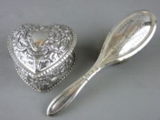 A HEART SHAPED SILVER DRESSING TABLE BOX with all over floral and scrolled design on a lift-off lid,