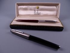 Vintage black Parker 25 fountain pen with 14k nib and a Vintage red Parker 51 fountain pen (with