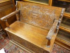 A GOOD CARVED OAK BOX SEAT MONK'S BENCH, 79 cms high closed, 105 cms wide, 47.5 cms deep