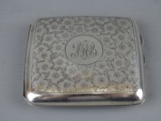 A FLORAL CHASED SILVER CIGARETTE CASE, Sheffield 1916, 3 troy ozs (monogrammed)