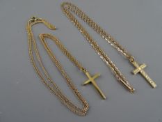 Two nine carat gold crucifixes (one bright cut), each with a chain, 4.4 and 6.5 grms respectively