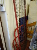 Old metal framed military hospital single bed with tubular metal bedends