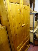 Modern pine two door wardrobe with two base drawers and a small pine bedside cabinet