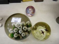 Three vintage glass paperweights by Caithness etc