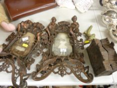 Pair of cherub decorated metallic picture frames, brass tap and similar items