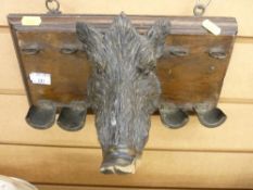 Carved boar's head pipe rack