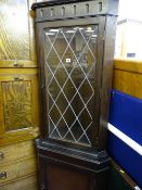 Polished standing corner cupboard with leaded glazed top