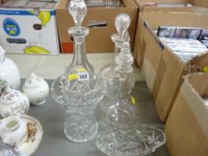 Three glass decanters with stoppers and other glassware
