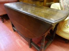 Oval topped oak drop leaf gate leg dining table