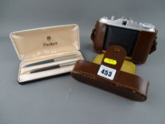 Cased Parker 51 ball and fountain pen set and a cased set of vintage binoculars
