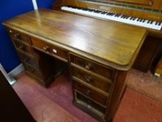 Pine kneehole desk with centre drawer and four drawers either side