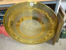 Large circular brass wall charger with chased floral decoration